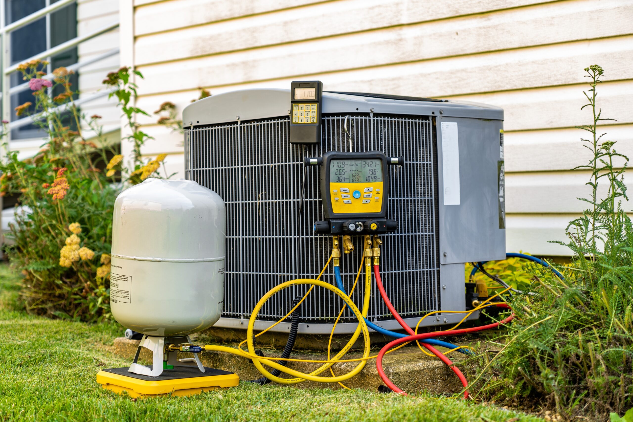 HVAC technician repairing an outdoor AC unit
